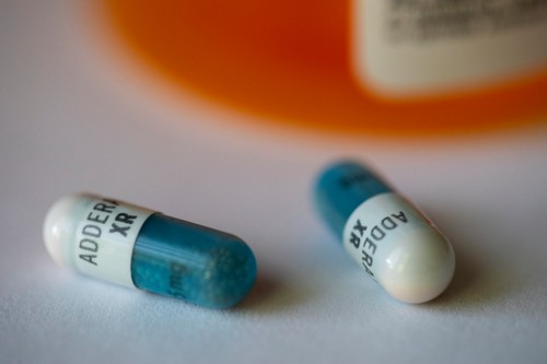Close up blue and white Adderall pills.